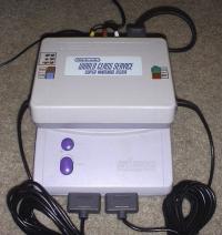 Tester plugged into SNES cart slot.