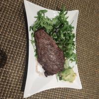 Beef steak with avocado, rocket salad and Parmesan