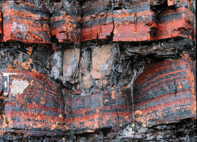 Figure showing a dropstone imbedded in a banded iron formations in Canada's Mackenzie Mountains.