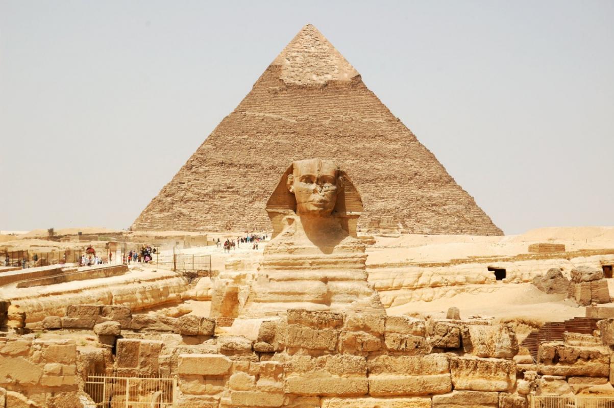 The Sphinx with a pyramid in the background