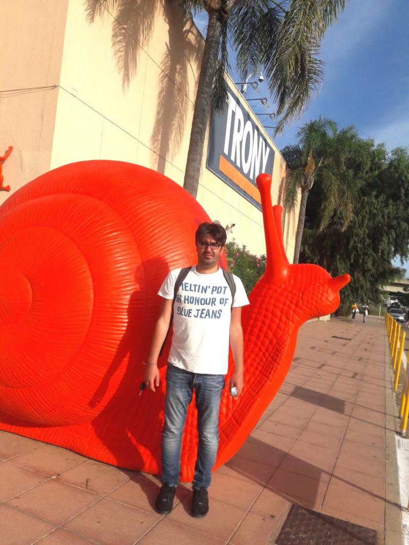 me next to the huge red snail at the main entrance of I Fenicotteri 