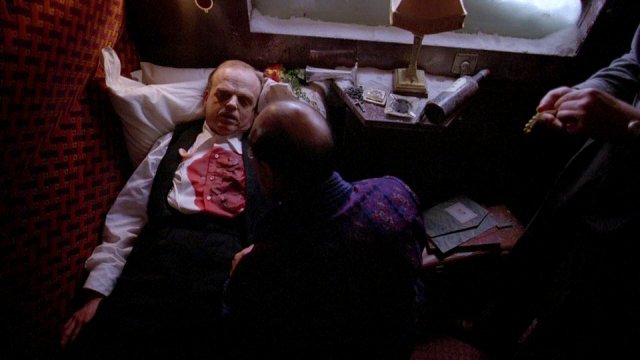 Poirot inspects the body of Mr. Ratchett.