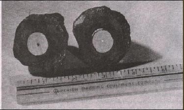 Coso's geode, sawn in two pieces, containing an object inside very similar to a spark plug of a mode