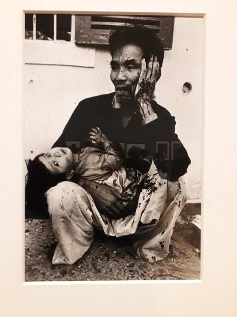 Father and daughter after a grenade-attack on their bunker, Hue