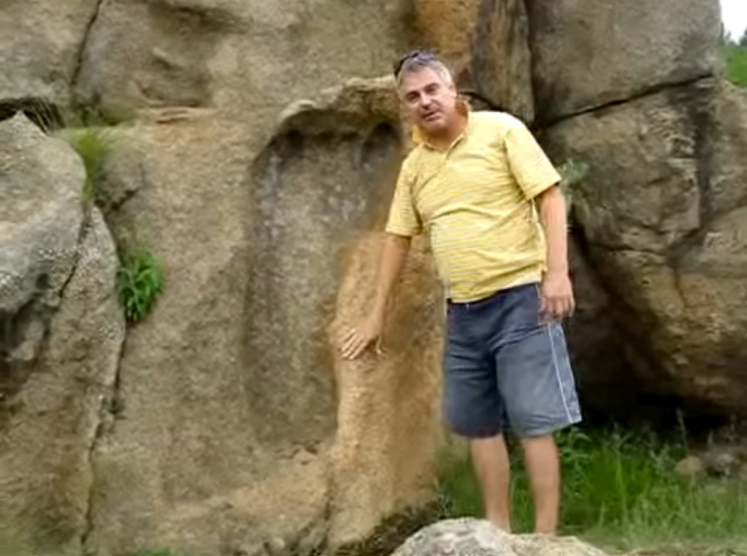 Michael Tellinger next to a giant footprint about 1.2 meters long