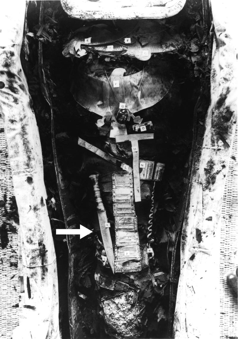 Black and white picture of Tutankhamun mummy showing the iron dagger (34.2 cm long) placed on the ri