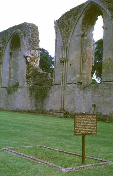 Remains of Glastonbury Abbey and, in the foreground, the site of the supposed tomb of Arthur and Gui