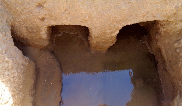 Water in the fully excavated chamber of the Hellenistic gate. On the right, the shape of the first p